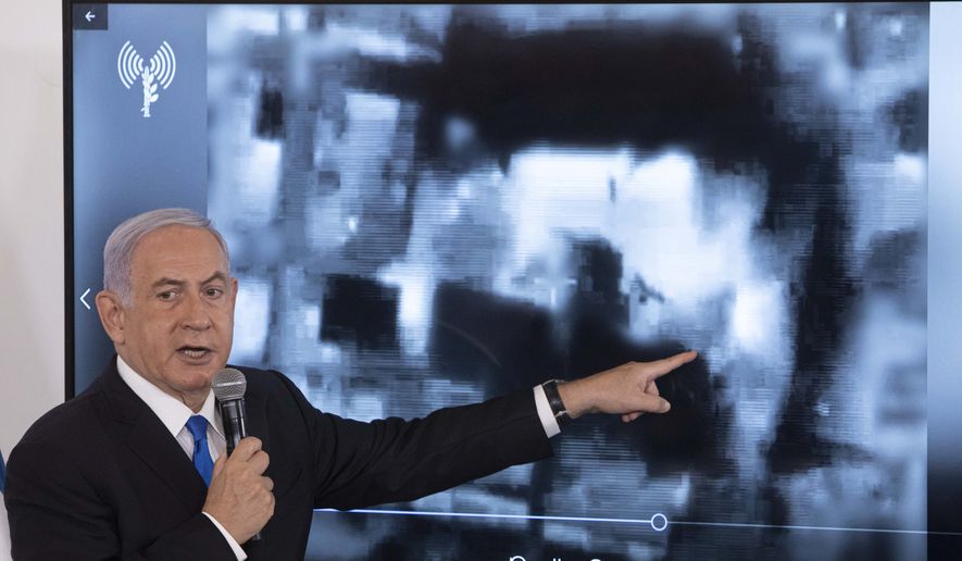 Israeli Prime Minister Benjamin Netanyahu gestures as he shows a slideshow during a briefing to ambassadors to Israel at the Hakirya military base in Tel Aviv, Israel, Wednesday, May 19, 2021. (AP Photo/Sebastian Scheiner, Pool)