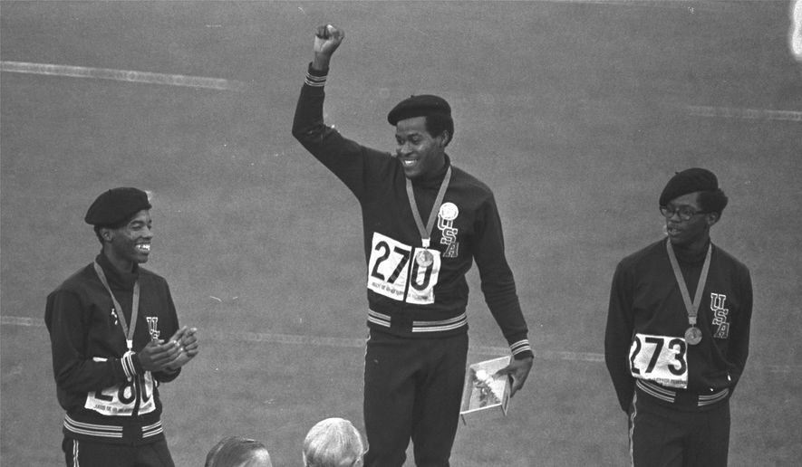 United States runners Larry James, left, Lee Evans, center, and Ron Freeman are shown after receiving their medals for the 400-meter race at the Mexico City Games in Mexico City, in this Oct. 18, 1968, file photo. Evans won gold, James took silver and Freeman got the bronze medal. Lee Evans, the record-setting sprinter who wore a black beret in a sign of protest at the 1968 Olympics, died Wednesday, May 19, 2021. He was 74. USA Track and Field confirmed Evans&#39; death. The San Jose Mercury News reported that Evans&#39; family had started a fundraiser with hopes of bringing him back to the U.S. from Nigeria, where he coached track, to receive medical care after he suffered a stroke last week.(AP Photo/File) **FILE**