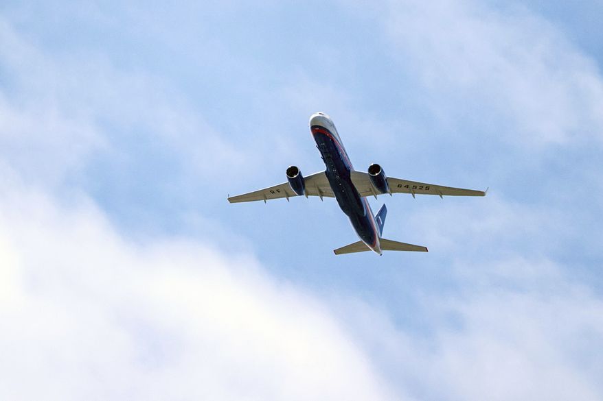 In this file photo taken on Friday, April 26, 2019, a Russian Air Force Tu-214 flies over Offutt Air Force Base, Friday, April 26, 2019, in Omaha, Neb. (Chris Machian/Omaha World-Herald via AP, File)