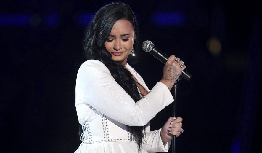 Demi Lovato performs "Anyone" at the 62nd annual Grammy Awards on Jan. 26, 2020, in Los Angeles. Lovato revealed on Wednesday, May 19, 2021, that they identify as nonbinary and are changing their pronouns, telling fans the decision came after “self-reflective work.” Lovato said they picked gender-neutral pronouns them and they as “this best represents the fluidity I feel in my gender expression.” (Photo by Matt Sayles/Invision/AP, File)
