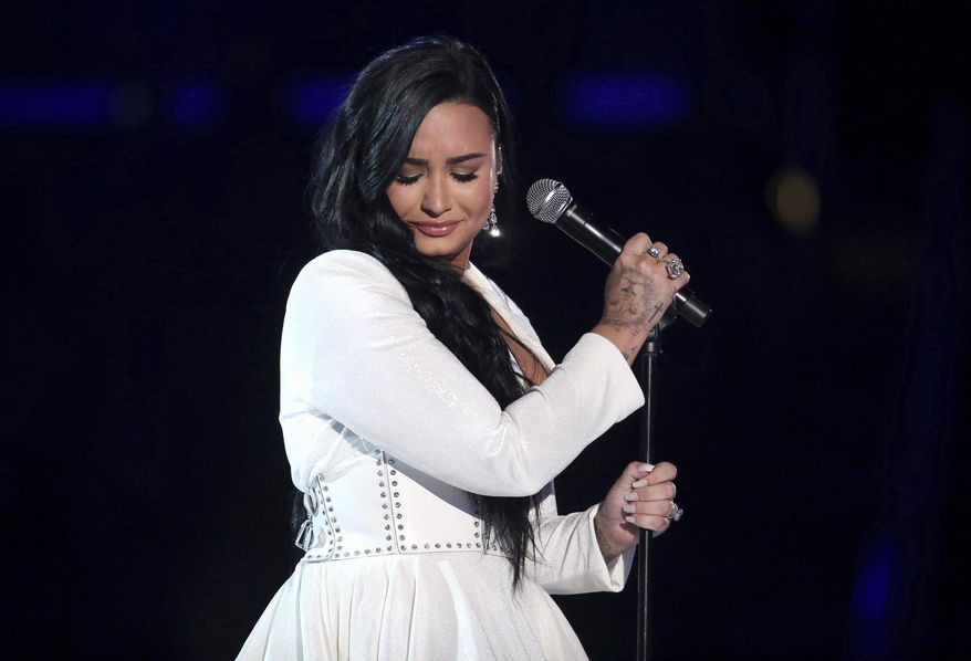 Demi Lovato performs &quot;Anyone&quot; at the 62nd annual Grammy Awards on Jan. 26, 2020, in Los Angeles. Lovato revealed on Wednesday, May 19, 2021, that they identify as nonbinary and are changing their pronouns, telling fans the decision came after “self-reflective work.” Lovato said they picked gender-neutral pronouns them and they as “this best represents the fluidity I feel in my gender expression.” (Photo by Matt Sayles/Invision/AP, File)