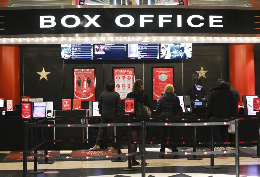 People line up for movie tickets at the reopened AMC Lincoln Square theater in New York on March 5, 2021. (Photo by Evan Agostini/Invision/AP, File)