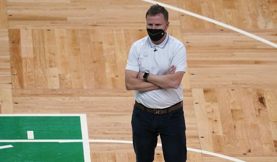 Washington Wizards head coach Scott Brooks stands on the court during a timeout in the second half of the team&#39;s NBA basketball Eastern Conference play-in game against the Boston Celtics, Tuesday, May 18, 2021, in Boston. (AP Photo/Charles Krupa)
