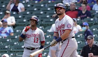 Washington Nationals&#39; Kyle Schwarber, right, watches his home run off Chicago Cubs starting pitcher Trevor Williams with teammate Starlin Castro during the first inning of a baseball game Thursday, May 20, 2021, in Chicago. (AP Photo/Charles Rex Arbogast)