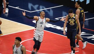 Washington Wizards guard Russell Westbrook (4) reacts next to Indiana Pacers forward Doug McDermott (20) and guard Malcolm Brogdon (7) during the second half of an NBA basketball Eastern Conference play-in game Thursday, May 20, 2021, in Washington. (AP Photo/Nick Wass)