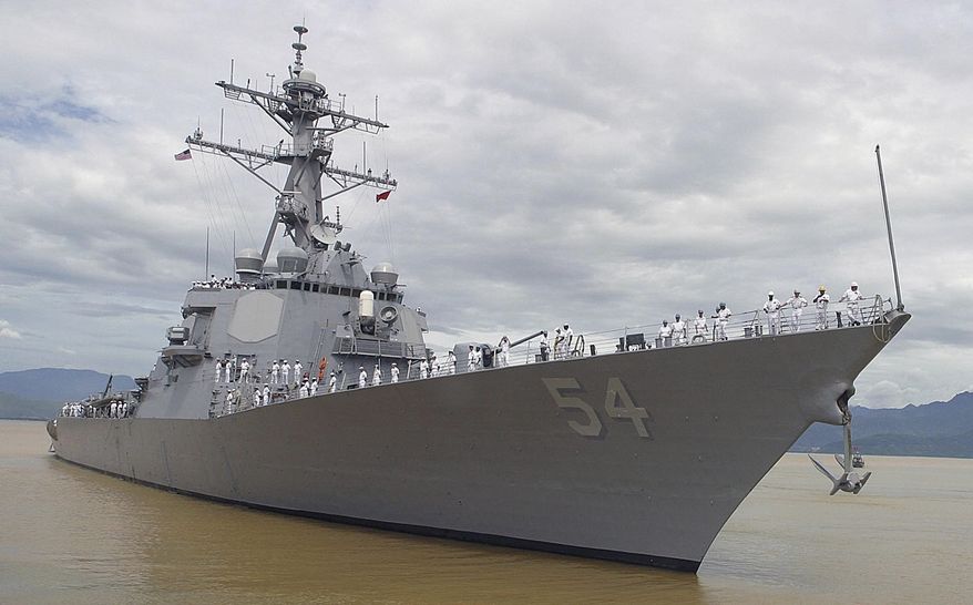 In this July 28, 2004, file photo, American sailors line the deck of the USS Curtis Wilbur, a guided missile destroyer as it arrives in Danang, Vietnam.  (AP Photo, File)  **FILE**