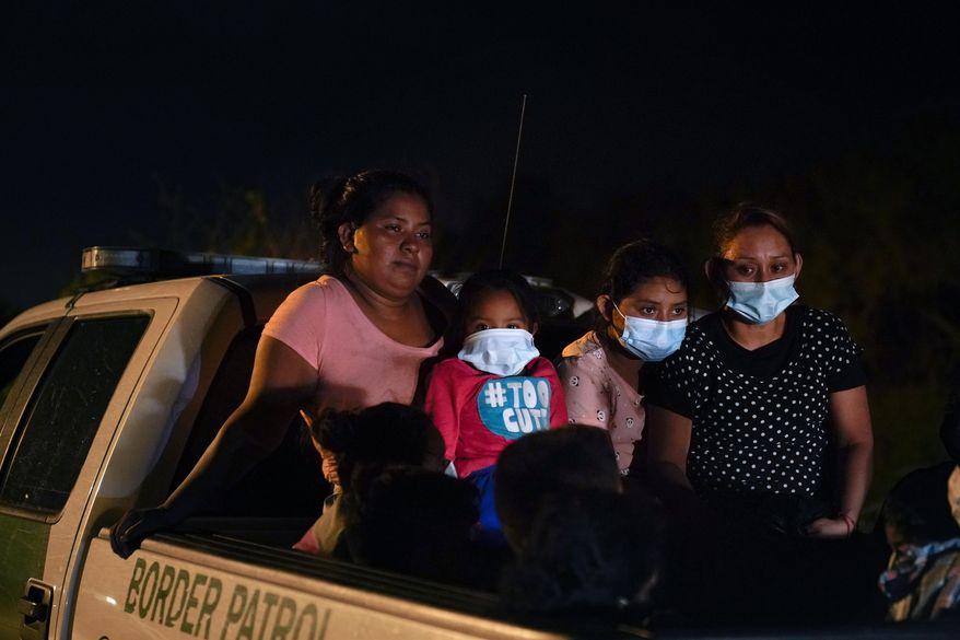 Migrants from Honduras wait in a Border Patrol truck after turning themselves in upon crossing the U.S.-Mexico border Monday, May 17, 2021, in La Joya, Texas. The Biden administration has agreed to let up to about 250 people a day in the United States at border crossings with Mexico to seek refuge, part of negotiations to settle a lawsuit over pandemic-related powers that deny migrants a right to apply for asylum, an attorney said Monday. (AP Photo/Gregory Bull)