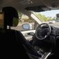 A Waymo minivan moves along a city street as an empty driver&#39;s seat and a moving steering wheel drive passengers during an autonomous vehicle ride, Wednesday, April 7, 2021, in Chandler, Ariz.  Waymo, a unit of Google parent Alphabet Inc., is one of several companies testing driverless vehicles in the U.S. But it&#39;s the first offering lifts to the public with no humans at the wheel who can take over in sticky situations. (AP Photo/Ross D. Franklin)