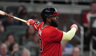 Atlanta Braves&#39; Marcell Ozuna (20) follows through on a solo home run during the sixth inning of the team&#39;s baseball game against the Pittsburgh Pirates on Friday, May 21, 2021, in Atlanta. (AP Photo/John Bazemore)