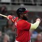 Atlanta Braves&#39; Marcell Ozuna (20) follows through on a solo home run during the sixth inning of the team&#39;s baseball game against the Pittsburgh Pirates on Friday, May 21, 2021, in Atlanta. (AP Photo/John Bazemore)