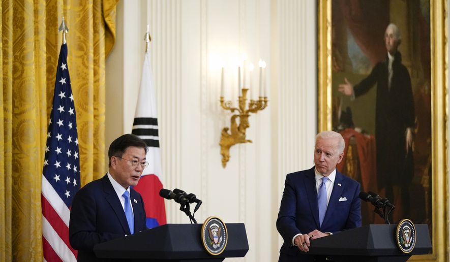 President Joe Biden listens as South Korean President Moon Jae-in speaks during a joint news conference in the East Room of the White House, Friday, May 21, 2021, in Washington. (AP Photo/Alex Brandon)