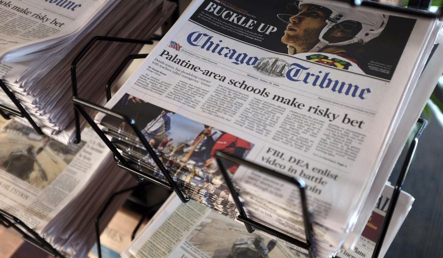 FILE - In this Monday, April 25, 2016, file photo, Chicago Tribune and other newspapers are displayed at Chicago&#39;s O&#39;Hare International Airport.  Shareholders of Tribune Publishing, one of the country’s largest newspaper chains, will vote Friday, May 21, 2021, on whether to be acquired by a hedge fund that already owns one-third of the company and favors aggressive cost-cutting to boost profits. (AP Photo/Kiichiro Sato, File)