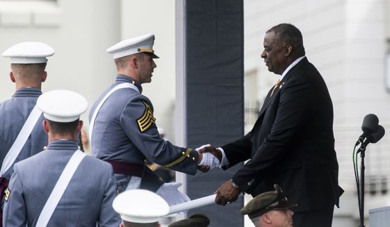 U.S. Defense Secretary Lloyd Austin hands out diplomas to United States Military Academy graduating cadets during the ceremony for class 2021 at Michie Stadium on Saturday, May 22, 2021, in West Point, N.Y. (AP Photo/Eduardo Munoz Alvarez)