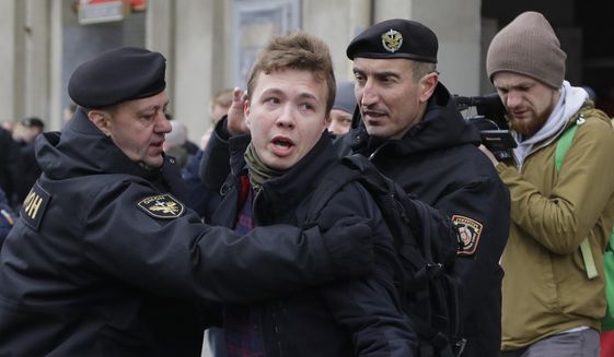 In this Sunday, March 26, 2017, file photo, Belarus police detain journalist Raman Pratasevich, center, in Minsk, Belarus. Raman Pratasevich, a founder of a messaging app channel that has been a key information conduit for opponents of Belarus’ authoritarian president, has been arrested after an airliner in which he was riding was diverted to Belarus because of a bomb threat. The presidential press service said President Alexander Lukashenko personally ordered that a MiG-29 fighter jet accompany the Ryanair plane — traveling from Athens, Greece, to Vilnius, Lithuania — to the Minsk airport. ﻿﻿(AP Photo/Sergei Grits, File)