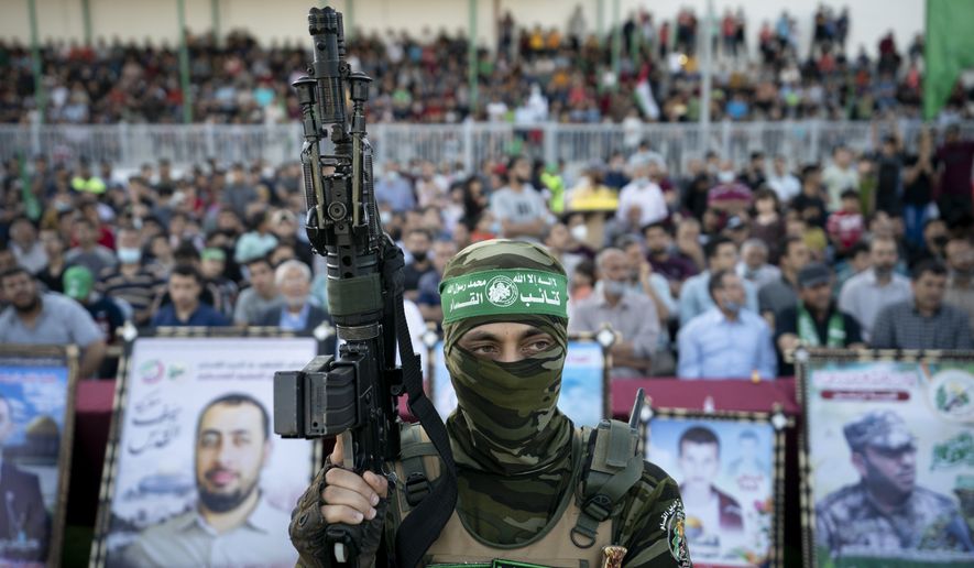 Militants stand guard around the stage as Yahya Sinwar, the Palestinian leader of Hamas in the Gaza Strip, makes a rally appearance days after a cease-fire was reached following an 11-day war between Gaza&#39;s Hamas rulers and Israel, Monday, May 24, 2021, in Gaza City, the Gaza Strip. (AP Photo/John Minchillo)