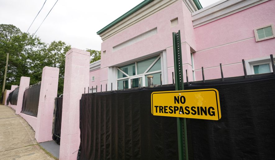 The Jackson Women&#39;s Health Organization clinic, also more commonly known as &amp;quot;The Pink House,&amp;quot; is shrouded with a black tarp so that its clients may enter in privacy, Wednesday, May 19, 2021, in Jackson, Miss. The Supreme Court agreed to take up a dispute over a Mississippi ban on abortions after 15 weeks of pregnancy, with their decision affecting whether the state&#39;s only medical facility will continue to be able to provide abortions on demand. (AP Photo/Rogelio V. Solis) **FILE**