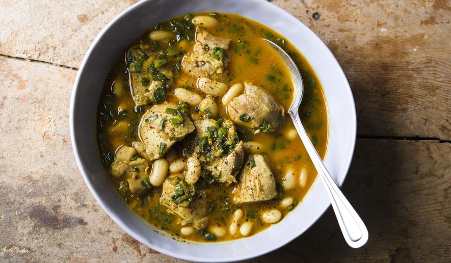 This image released by Milk Street shows a recipe for cardamom lime chicken with white beans. (Milk Street via AP)