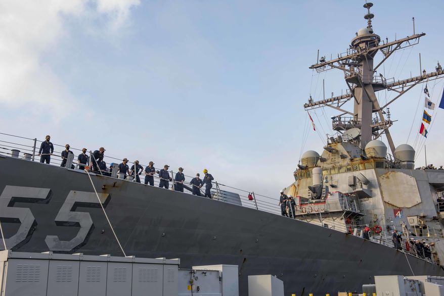 In this photo provided by the U.S. Navy, sailors aboard the guided-missile destroyer USS Stout handle mooring lines during the ship&#x27;s return to home port at Naval Station Norfolk, in Norfolk, Va., in this Oct. 12, 2020, photo. The USS Stout showed rust as it returned from the 210-day deployment. The rust was quickly removed and the ship repainted. But the rusty ship and its weary crew underscored the costly toll of deferred maintenance on ships and long deployments on sailors. (Spc. Jason Pastrick/U.S. Navy via AP) **FILE**
