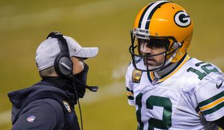 In this Jan. 3, 2021, file photo, Green Bay Packers head coach Matt LaFleur, left, talks to Aaron Rodgers during the second half of an NFL football game against the Chicago Bears in Chicago. LaFleur reiterated his hope that he’d get to continue working with Rodgers this season while offering no news on the quarterback’s status. (AP Photo/Charles Rex Arbogast, File) **FILE**