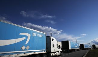This April 21, 2020, photo shows Amazon tractor-trailers line up outside the Amazon Fulfillment Center in the Staten Island borough of New York. The District of Columbia has sued Amazon, Tuesday, May 25, 2021, accusing the online retail giant of illegal anticompetitive practices in its treatment of sellers on its platform. (AP Photo/Mark Lennihan) **FILE**