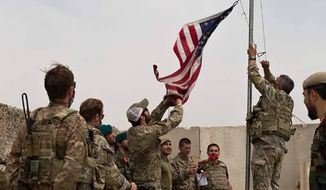 In this May 2, 2021, photo, a U.S. flag is lowered as American and Afghan soldiers attend a handover ceremony from the U.S. Army to the Afghan National Army at Camp Anthonic in the Helmand province of southern Afghanistan. The Taliban on Wednesday, May 26, 2021, warned the departing U.S. military against setting up bases in the region, and Pakistan vowed no American bases will be allowed on its territory. (Afghan Ministry of Defense Press Office via AP) ** FILE **