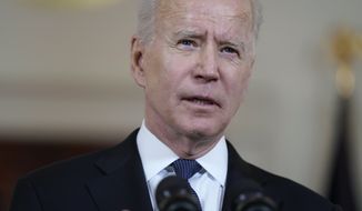 In this Thursday, May 20, 2021, photo, President Joe Biden speaks in the Cross Hall of the White House in Washington. Biden is asking U.S. intelligence agencies to “redouble” efforts to investigate the origins of the COVID-19 pandemic. He says there is insufficient evidence to conclude “whether it emerged from human contact with an infected animal or from a laboratory accident.” (AP Photo/Evan Vucci) **FILE**
