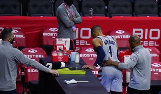 Washington Wizards&#39; Russell Westbrook (4) is helped to the locker room after an injury during the second half of Game 2 in a first-round NBA basketball playoff series against the Philadelphia 76ers, Wednesday, May 26, 2021, in Philadelphia. (AP Photo/Matt Slocum)