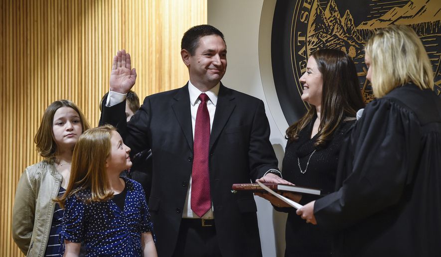 In this Jan. 4, 2021, photo Montana Attorney General Austin Knudsen is sworn into office, inside the Montana State Capitol in Helena, Mont. Knudsen issued an opinion Thursday, May 27, 2021, labeling critical race theory and some antiracism programs taught in schools as &quot;discriminatory&quot; and said they violate federal and state law. The Republican Attorney General&#x27;s decision bans the activities which are also used for employee training in the state. (Thom Bridge/Independent Record via AP) **FILE**