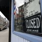 In this May 12, 2020, photo, a pedestrian passes a closed barbershop during the coronavirus pandemic, in the North End neighborhood of Boston. Many small-business owners took on debt to weather the coronavirus pandemic, which forced lockdowns and decimated revenues for large sectors of the economy. Now, those business owners are faced with repaying this debt and rebuilding their companies.  (AP Photo/Steven Senne) **FILE**