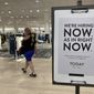 A customer walks behind a sign at a Nordstrom store seeking employees, Friday, May 21, 2021, in Coral Gables, Fla. The number of Americans seeking unemployment benefits dropped last week to 406,000, a new pandemic low and more evidence that the job market is strengthening as the virus wanes and economy further reopens. (AP Photo/Marta Lavandier)