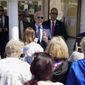 President Joe Biden talks with people as he holds an ice cream cone at Honey Hut Ice Cream, Thursday, May 27, 2021, in Cleveland. (AP Photo/Evan Vucci)