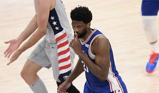 Philadelphia 76ers center Joel Embiid (21) gestures after he made a basket during the first half of Game 3 in a first-round NBA basketball playoff series against the Washington Wizards, Saturday, May 29, 2021, in Washington. (AP Photo/Nick Wass)