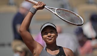 Japan&#39;s Naomi Osaka celebrates after defeating Romania&#39;s Patricia Maria Tig during their first round match of the French open tennis tournament at the Roland Garros stadium Sunday, May 30, 2021 in Paris. (AP Photo/Christophe Ena)