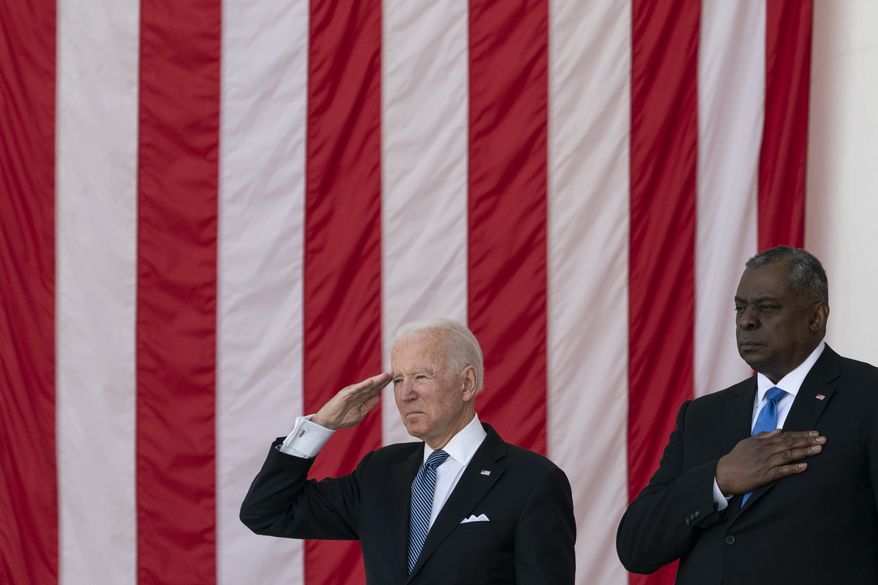 President Joe Biden salutes as Secretary of Defense Lloyd Austin places his hand over heart during the playing of &quot;Taps,&quot; during the National Memorial Day Observance at the Memorial Amphitheater in Arlington National Cemetery, Monday, May 31, 2021, in Arlington, Va.(AP Photo/Alex Brandon)