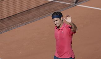 Switzerland&#39;s Roger Federer waves to the crowd after defeating Uzbekistan&#39;s Denis Istomin during their first round match on day two of the French Open tennis tournament at Roland Garros in Paris, France, Monday, May 31, 2021. (AP Photo/Thibault Camus)