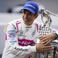 Helio Castroneves of Brazil, winner of the 2021 Indianapolis 500 auto race, poses during the traditional winners photo session at the Indianapolis Motor Speedway in Indianapolis, Monday, May 31, 2021. (AP Photo/Michael Conroy)