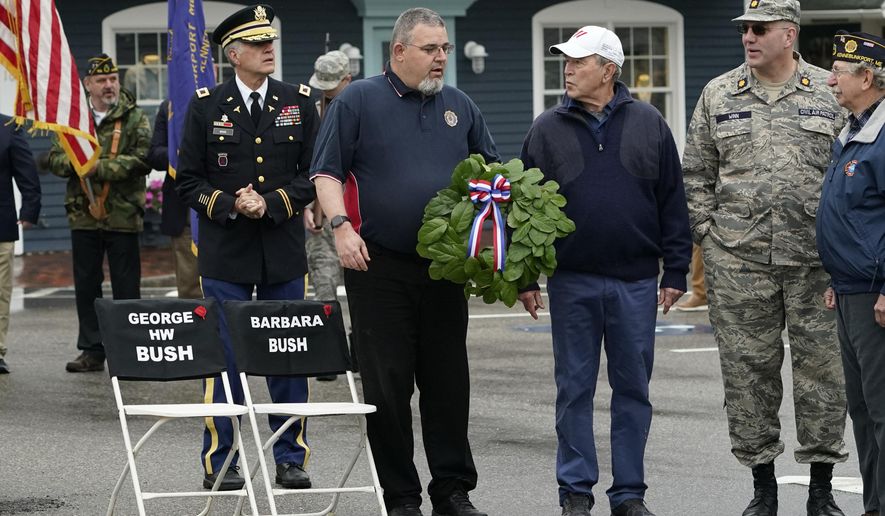 Former President George W. Bush attends a wreath-laying ceremony near two chairs honoring his late parents, former President George H. W. Bush and former first lady Barbara Bush, in Dock Square, during a Memorial Day service in Kennebunkport, Maine, Monday, May 31, 2021. The late president and his wife made a point of attending the annual Memorial Day parade. This year's parade was canceled. (AP Photo/Robert F. Bukaty)