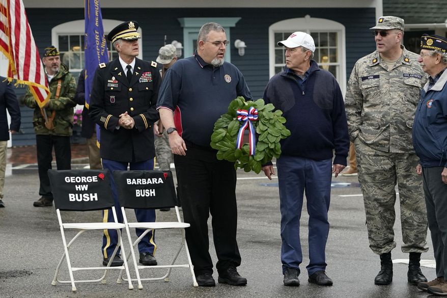 Former President George W. Bush attends a wreath-laying ceremony near two chairs honoring his late parents, former President George H. W. Bush and former first lady Barbara Bush, in Dock Square, during a Memorial Day service in Kennebunkport, Maine, Monday, May 31, 2021. The late president and his wife made a point of attending the annual Memorial Day parade. This year's parade was canceled. (AP Photo/Robert F. Bukaty)