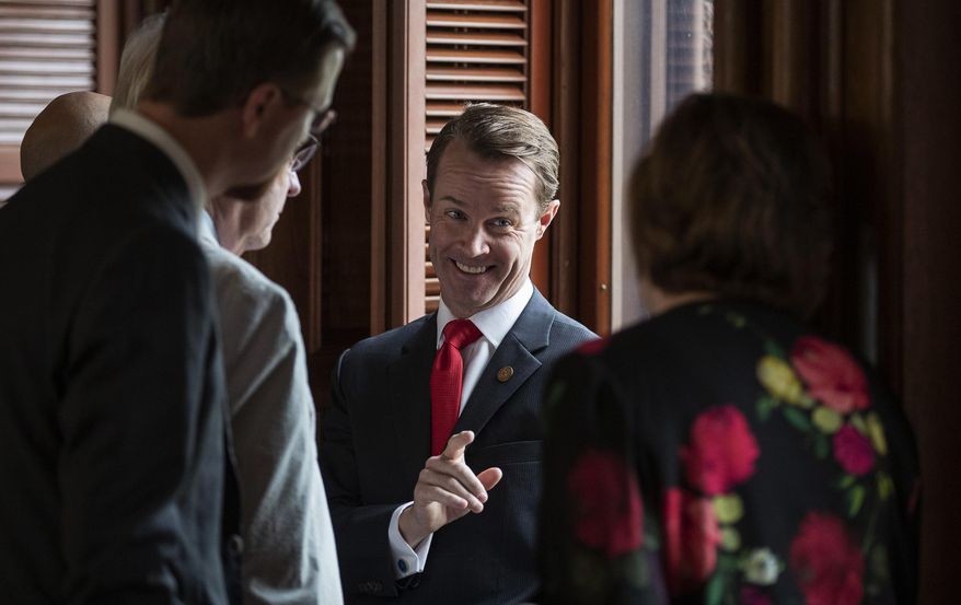 House Speaker Dade Phelan, R-Beaumont, talks to Republican members of the Texas House before the start of the debate of Senate Bill 7, known as the Election Integrity Protection Act, at the Capitol on Sunday, May 30, 2021, in Austin, Texas. (Jay Janner/Austin American-Statesman via AP)