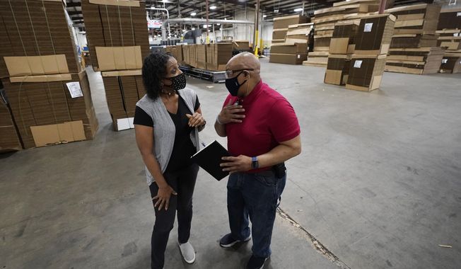 Charita McCarrol, human resources manager at Great Southern Industries, a packaging company in Jackson, Miss., left, confers with second shift production manager James Chapman, Friday, May 28, 2021. McCarrol said she has seen people abusing the $300-a-week federal supplement for people who lost their jobs during the COVID-19 pandemic, as well as other programs that offered extended support for the unemployed. &amp;quot;You can&#x27;t get people to come to work,&amp;quot; McCarrol said. &amp;quot;It has been an absolute nightmare in the world of staffing agencies.&amp;quot; (AP Photo/Rogelio V. Solis)