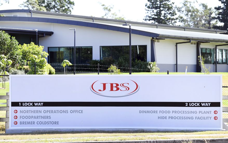 In this May 12, 2020, photo, the company logo sign sits at the entrance to the JBS Australia&#39;s Dinmore meatworks facility, west of Brisbane. Thousands of Australian meat workers had no work for a second day on Tuesday, June 1, 2021, after a cyberattack crippled the worlds largest meat processing company. A government minister said it might be days before production resumes. (Dan Peled/AAP Image via AP)