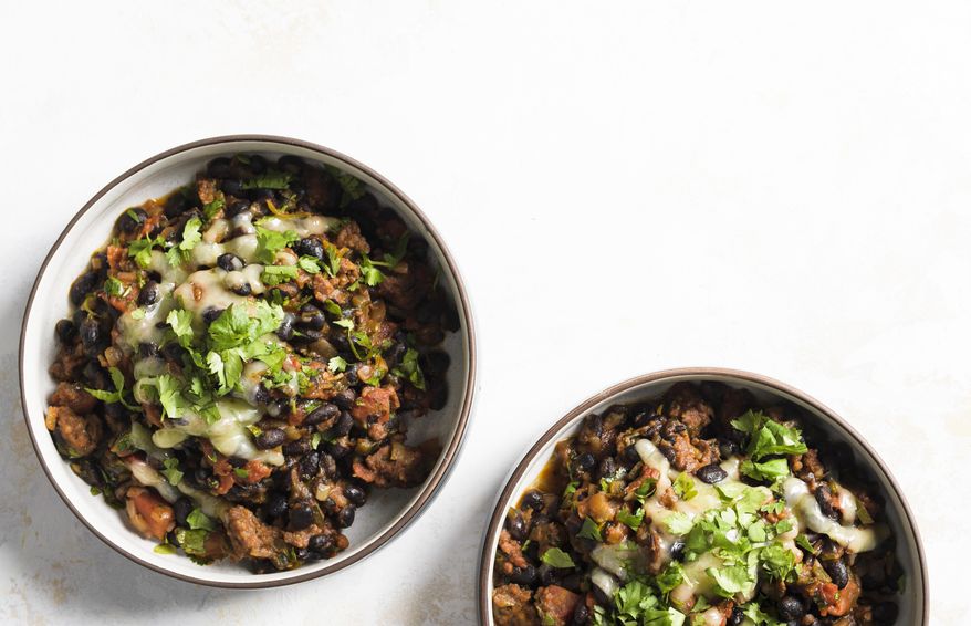 This image released by Milk Street shows a recipe for black bean stew with chorizo. (Milk Street via AP)
