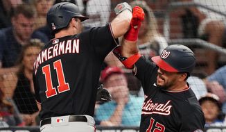 Washington Nationals&#39; Ryan Zimmerman (11) celebrates with Kyle Schwarber (12) after hitting a two-run home run in the fourth inning of a baseball game against the Atlanta Braves Tuesday, June 1, 2021, in Atlanta. (AP Photo/John Bazemore)