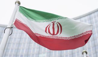 FILE - In this Monday, May 24, 2021 file photo, the flag of Iran waves in front of the the International Center building with the headquarters of the International Atomic Energy Agency, IAEA, in Vienna, Austria, Monday, May 24, 2021. (AP Photo/Florian Schroetter, FILE)