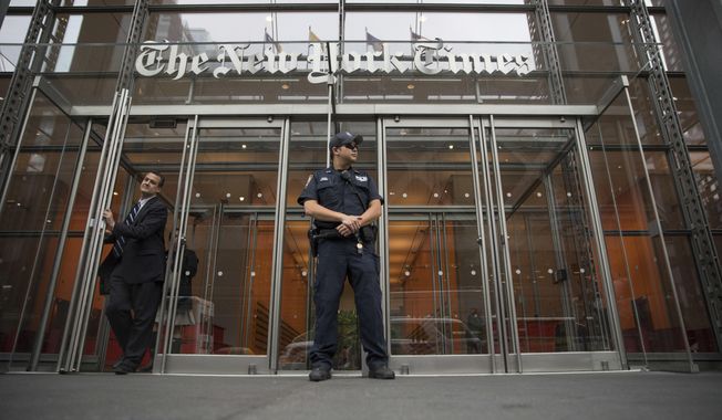 A police officer stands outside The New York Times building in New York, June 28, 2018. Trump Justice Department secretly obtained the phone records of four New York Times journalists as part of a leak investigation, the newspaper said Wednesday, June 2, 2021. (AP Photo/Mary Altaffer) ** FILE **