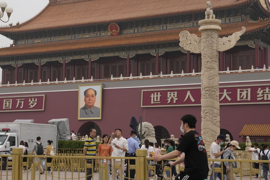 Visitors take in the sights in front of the Tiananmen Gate in Beijing on Wednesday, June 2, 2021. Communist Party leaders have imprisoned or driven activists into exile and largely succeeded in ensuring young people know little about the June 4, 1989, deadly crackdown on pro-democracy movement. But after three changes of leadership since then, they are relentless in trying to prevent any mention of the military attack that killed hundreds and possibly thousands of people. (AP Photo/Ng Han Guan)