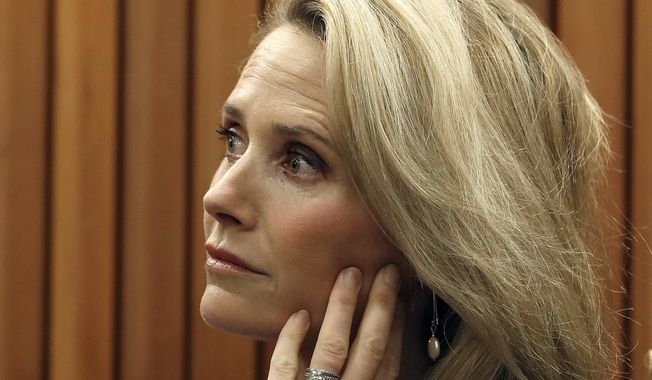 In this May 9, 2019 file photo First partner Jennifer Siebel Newsom listens as her husband, Gov. Gavin Newsom, discusses his revised state budget during a news conference, in Sacramento, Calif. California Gov. Gavin Newsom said he “absolutely” sees no conflict of interest with a nonprofit launched by his wife accepting donations from companies that lobby his administration.  (AP Photo/Rich Pedroncelli,File)