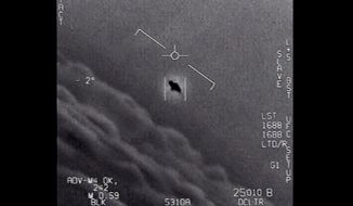 In this image from video provided by the Department of Defense labeled Gimbal, from 2015, an unexplained object is seen at the center as it is tracked as it soars high along the clouds, traveling against the wind. (Department of Defense via AP) **FILE**