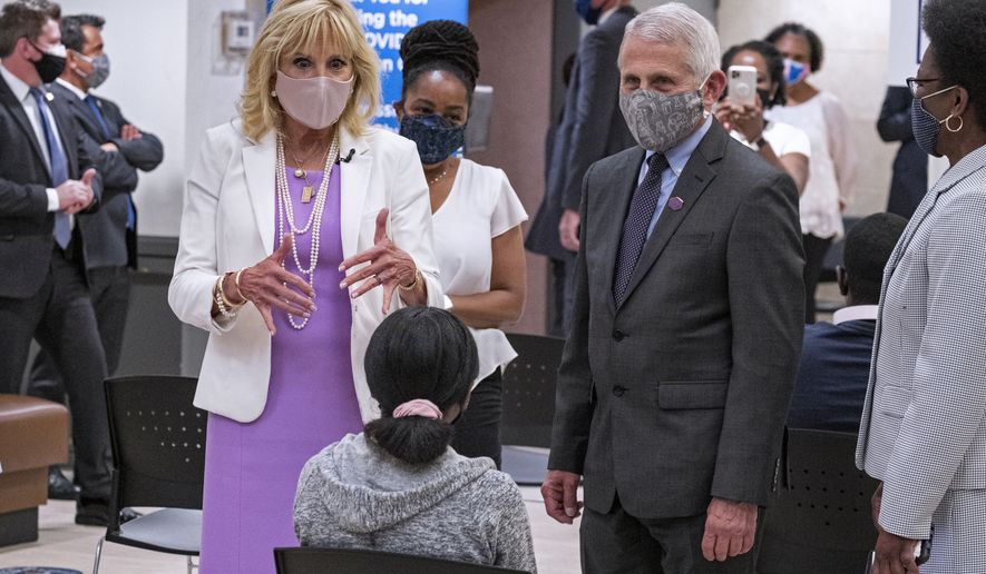 First lady Jill Biden, center left, and Dr. Anthony Fauci, director of the National Institute of Allergy and Infectious Diseases, speak to a person as they visit a vaccine clinic at the Abyssinian Baptist Church in the Harlem neighborhood of New York Sunday, June 6, 2021. (AP Photo/Craig Ruttle)