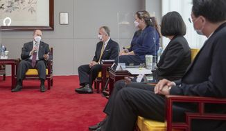 In this photo released by the Taiwan Presidential Office, U.S. Democratic Sen. Christopher Coons of Delaware, left, speaks near Republican Sen. Dan Sullivan of Alaska and Democratic Sen. Tammy Duckworth of Illinois during a meeting with Taiwan President Tsai Ing-wen, second right, in Taipei, Taiwan on Sunday, June 6,2021. The U.S. will give Taiwan 750,000 doses of COVID-19 vaccine, part of President Joe Biden&#39;s move to share tens of millions of jabs globally, three American senators said Sunday, after the self-ruled island complained that China is hindering its efforts to secure vaccines as it battles an outbreak. (Taiwan Presidential Office via AP)